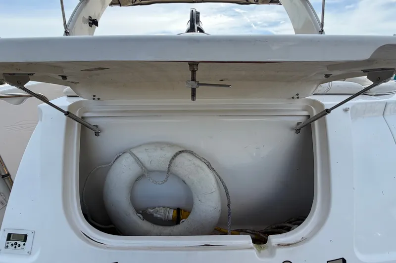 Slide: The Image of Open storage compartment on 2008 Chaparral Signature 290 boat with life preserver inside. - 16