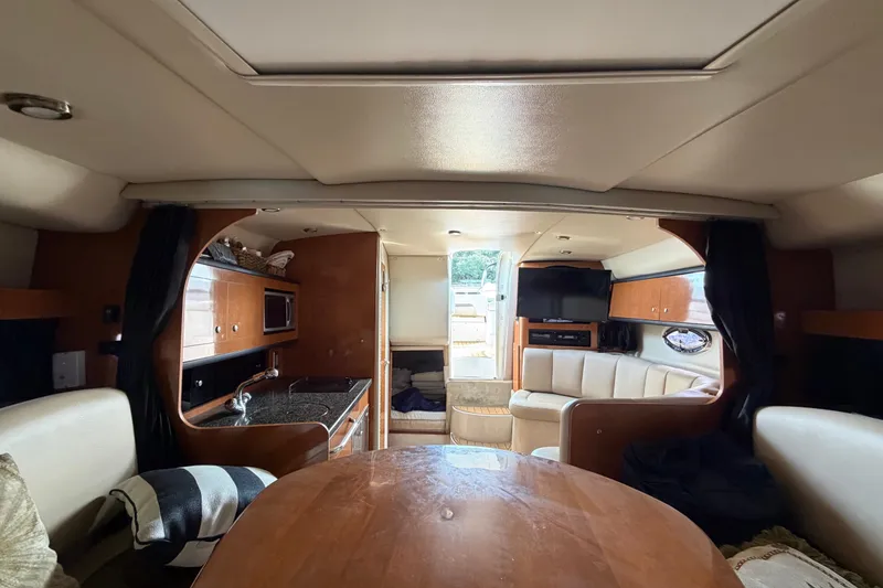 Slide: The Image of Interior of 2008 Chaparral Signature 290 yacht with kitchen, seating, and entertainment area. - 27