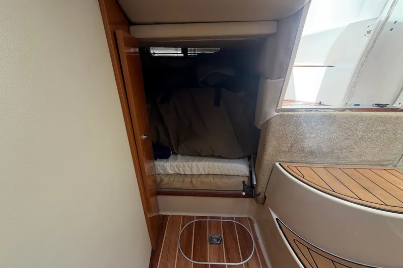 Slide: The Image of 2008 Chaparral Signature 290 cabin interior with wood accents and cozy sleeping area. - 89