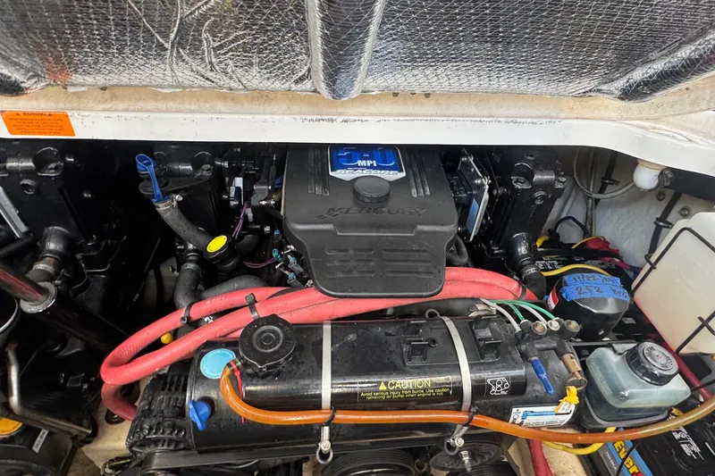 Slide: The Image of Engine compartment of a 2008 Chaparral Signature 290 boat, featuring Mercury components. - 71
