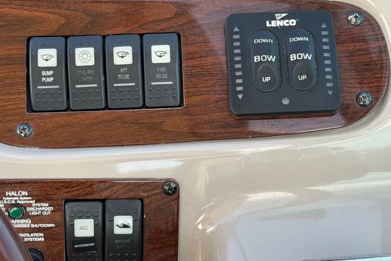 Slide: The Image of Control panel of a 2008 Chaparral Signature 290 boat with switches and trim tabs. - 19