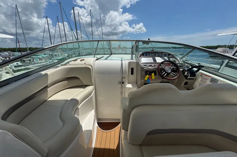 Slide: The Image of 2008 Chaparral Signature 290 boat interior with helm, seating, and dashboard under blue sky. - 17