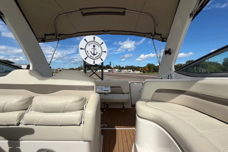 Slide: The Image of 2008 Chaparral Signature 290 boat interior with beige seating and open canopy. - 105