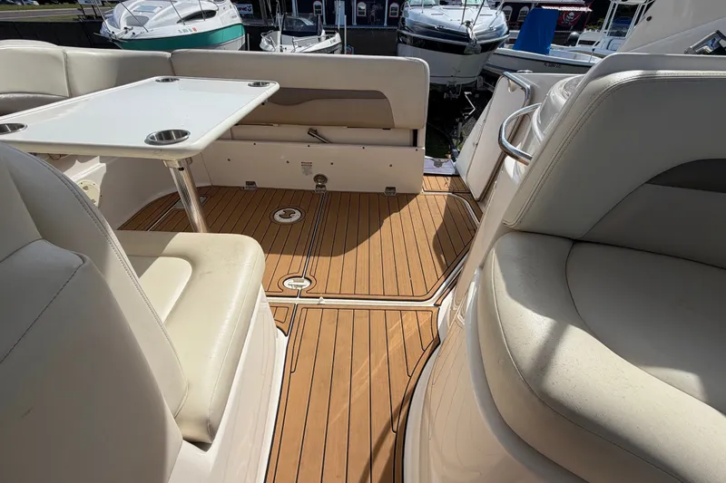 Slide: The Image of 2008 Chaparral Signature 290 boat interior with teak flooring and white seating. - 35