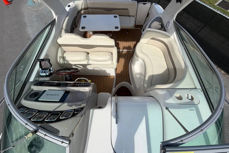 Slide: The Image of 2008 Chaparral Signature 290 boat interior with seating, table, and control panel. - 104