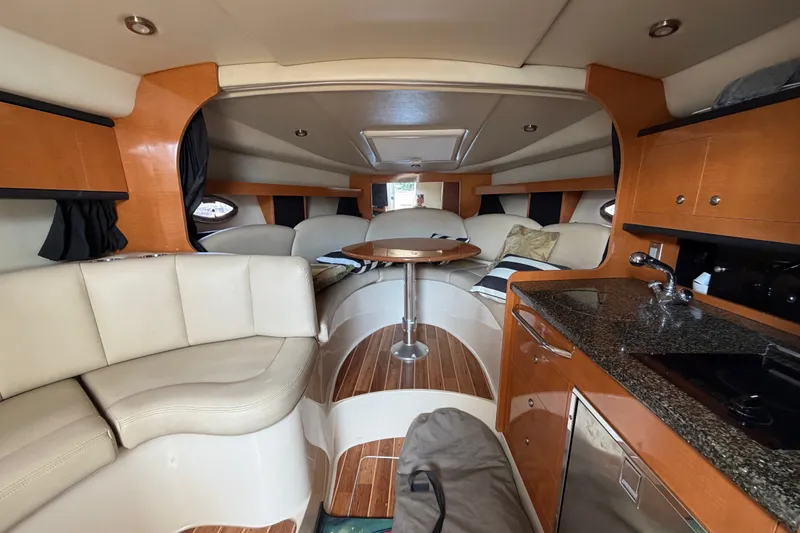 Slide: The Image of Luxurious interior of 2008 Chaparral Signature 290 yacht with seating, table, and kitchenette. - 24