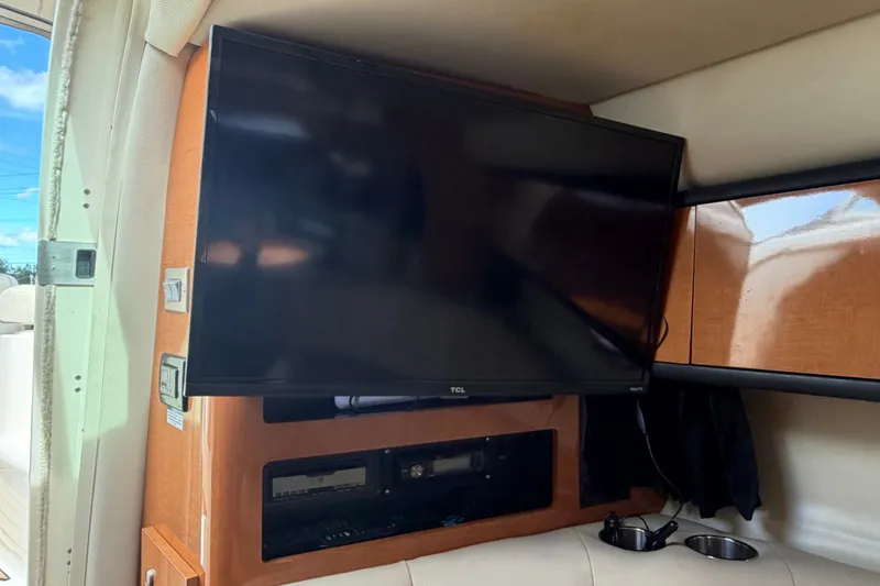 Slide: The Image of Flat-screen TV in 2008 Chaparral Signature 290 boat interior, with wood paneling and seating. - 50