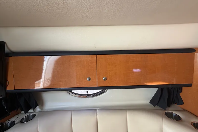 Slide: The Image of 2008 Chaparral Signature 290 interior with wooden cabinet and porthole window. - 52