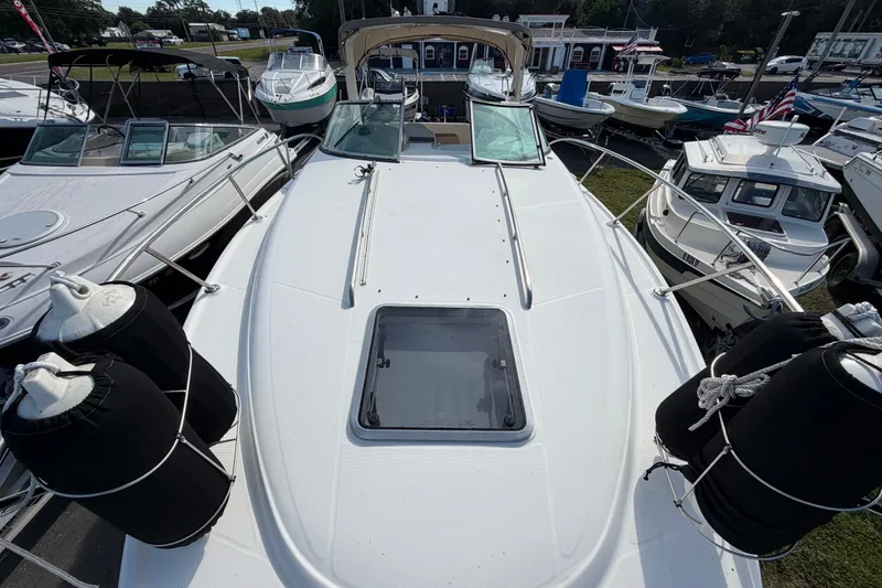 Slide: The Image of 2008 Chaparral Signature 290 boat docked among other vessels at a marina. - 32