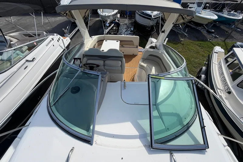 Slide: The Image of 2008 Chaparral Signature 290 boat with open cockpit and windshield, docked among other boats. - 33