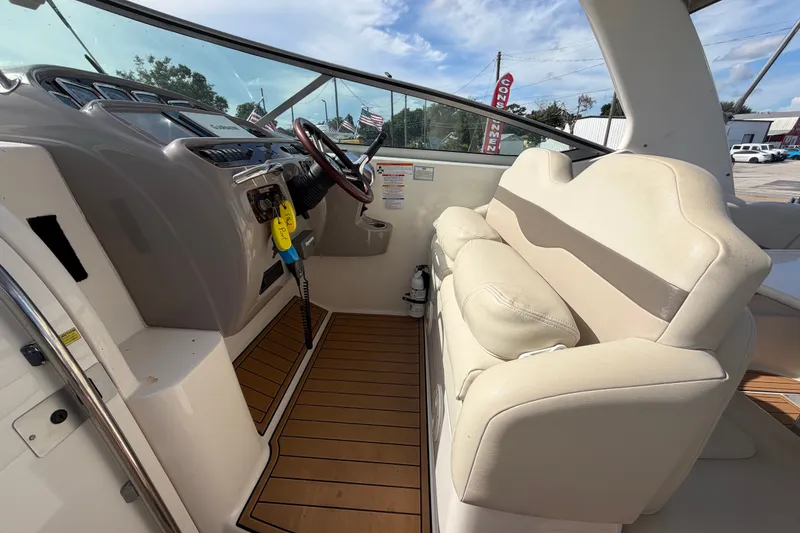 Slide: The Image of 2008 Chaparral Signature 290 boat interior with beige seating and wooden flooring. - 29
