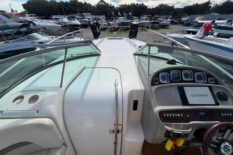 Slide: The Image of 2008 Chaparral Signature 290 boat dashboard with Garmin navigation, docked among other boats. - 42