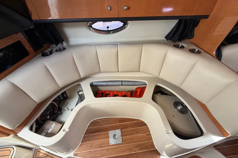 Slide: The Image of 2008 Chaparral Signature 290 interior with white seating and storage compartments. - 56