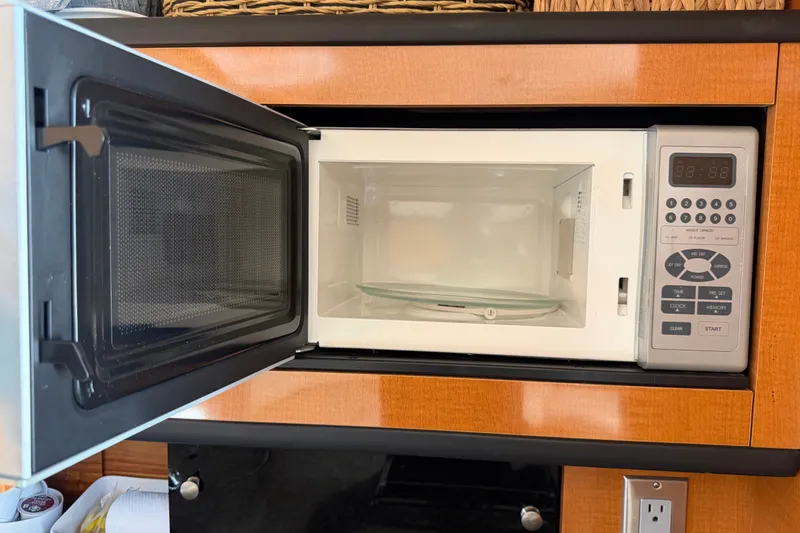 Slide: The Image of Microwave oven inside 2008 Chaparral Signature 290 boat, with open door and control panel. - 74