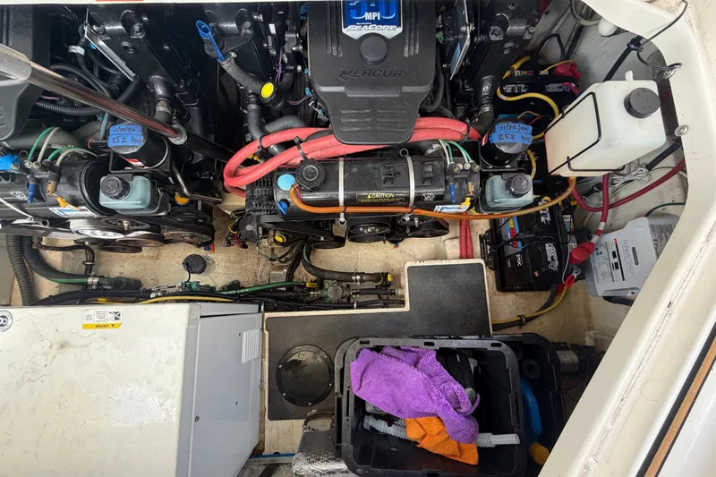 Slide: The Image of Engine compartment of a 2008 Chaparral Signature 290 boat, featuring various components and tools. - 110