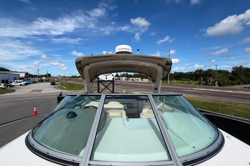 Slide: The Image of 2008 Chaparral Signature 290 boat with Garmin equipment, parked under a clear blue sky. - 102