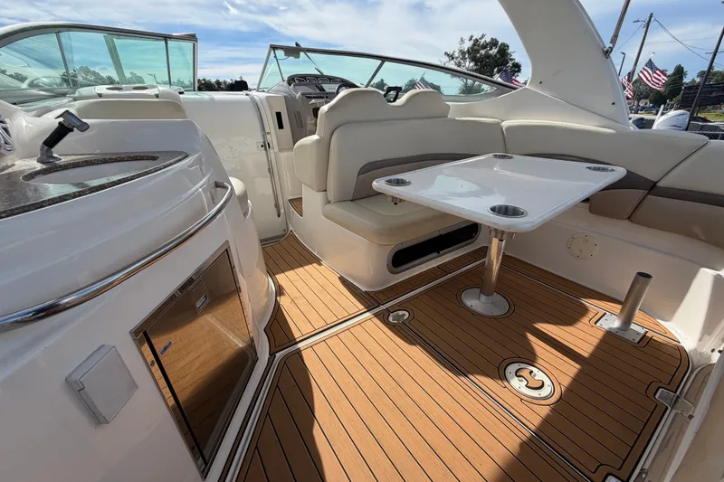 Slide: The Image of 2008 Chaparral Signature 290 boat interior with seating, table, and kitchenette. - 19