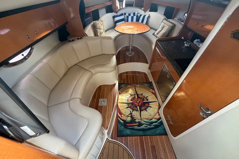 Slide: The Image of Interior of 2008 Chaparral Signature 290 boat with seating, table, and kitchenette. - 45
