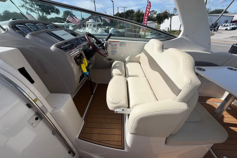 Slide: The Image of 2008 Chaparral Signature 290 boat interior with beige seating and modern dashboard. - 28