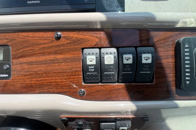 Slide: The Image of Dashboard switches on a 2008 Chaparral Signature 290 boat, featuring sump pump and bilge controls. - 57