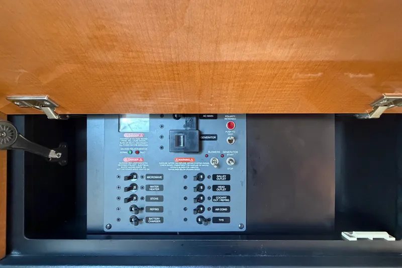 Slide: The Image of Electrical control panel in a 2008 Chaparral Signature 290 boat, featuring various switches and warnings. - 53