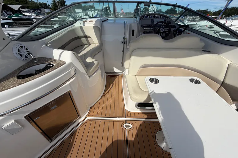 Slide: The Image of 2008 Chaparral Signature 290 boat interior with seating, table, and helm. - 13