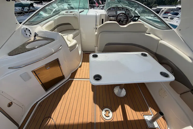 Slide: The Image of 2008 Chaparral Signature 290 boat interior with seating, table, and helm. - 18