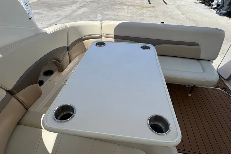 Slide: The Image of 2008 Chaparral Signature 290 boat interior with seating and table featuring cup holders. - 51