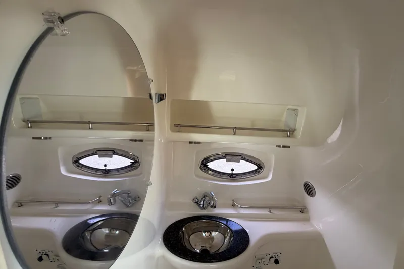 Slide: The Image of 2008 Chaparral Signature 290 bathroom interior with mirror, sink, and porthole window. - 85