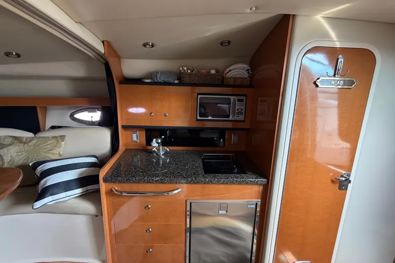 Slide: The Image of 2008 Chaparral Signature 290 yacht interior with kitchenette and head door. - 25