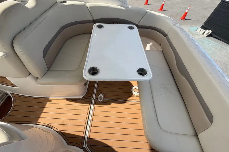 Slide: The Image of The image shows the seating area of a Chaparral Signature 290 boat with a table. - 23