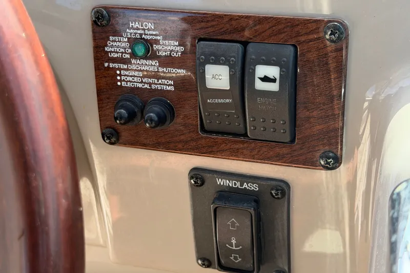 Slide: The Image of Control panel of a 2008 Chaparral Signature 290 boat with switches and warning labels. - 38