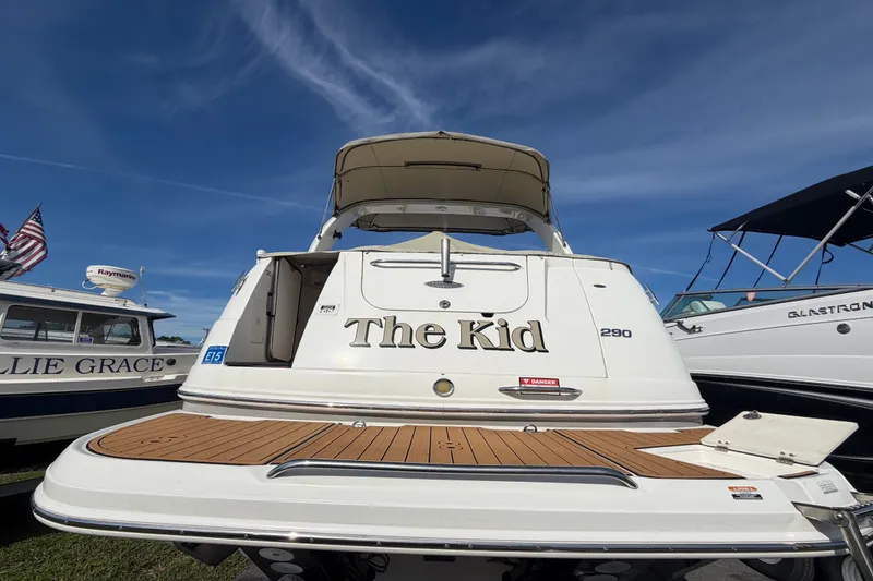 Slide: The Image of 2008 Chaparral Signature 290 boat named "The Kid" docked under clear skies. - 2