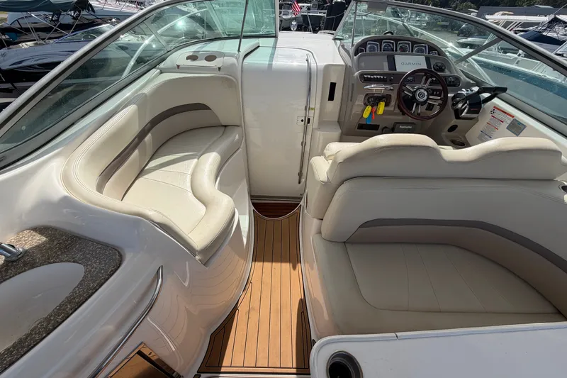 Slide: The Image of 2008 Chaparral Signature 290 boat interior with beige seating and modern dashboard. - 24