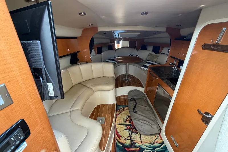 Slide: The Image of Interior of 2008 Chaparral Signature 290 boat with seating, table, and kitchenette. - 22