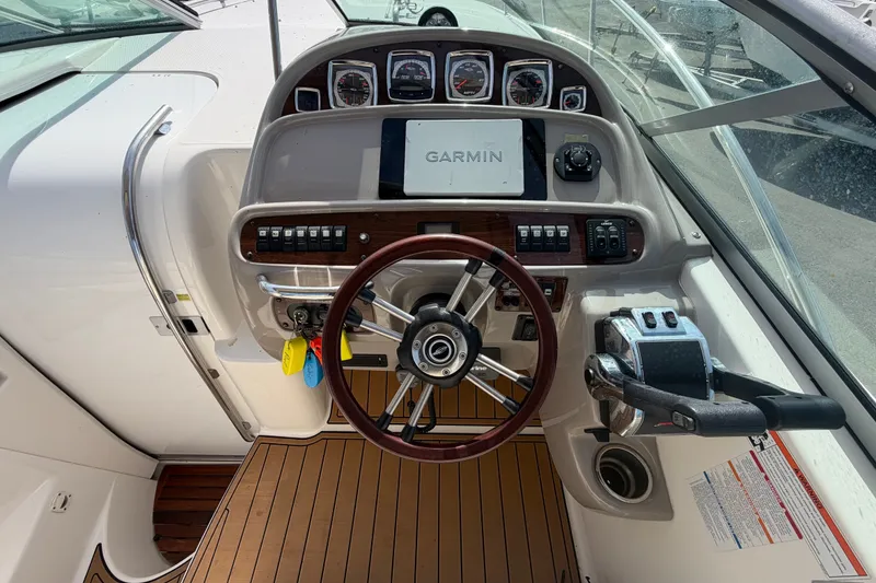 Slide: The Image of 2008 Chaparral Signature 290 boat dashboard with Garmin navigation system and wooden steering wheel. - 30