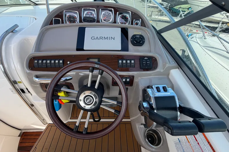 Slide: The Image of 2008 Chaparral Signature 290 helm with Garmin navigation, wood accents, and modern controls. - 16