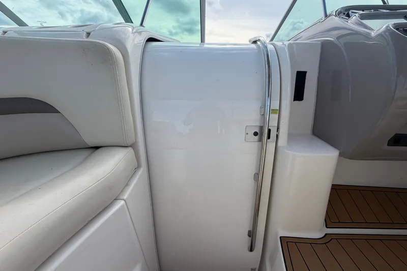 Slide: The Image of 2008 Chaparral Signature 290 interior with white seating and sleek design elements. - 43