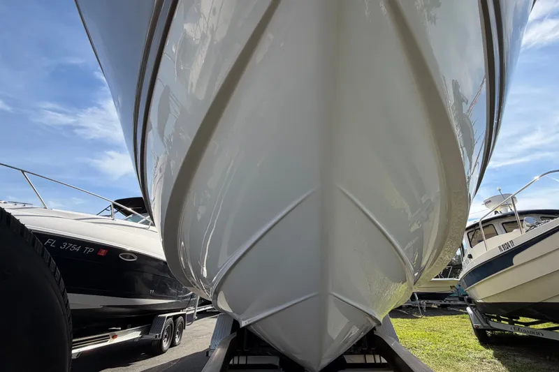 Slide: The Image of 2008 Chaparral Signature 290 boat hull on trailer, surrounded by other boats. - 10