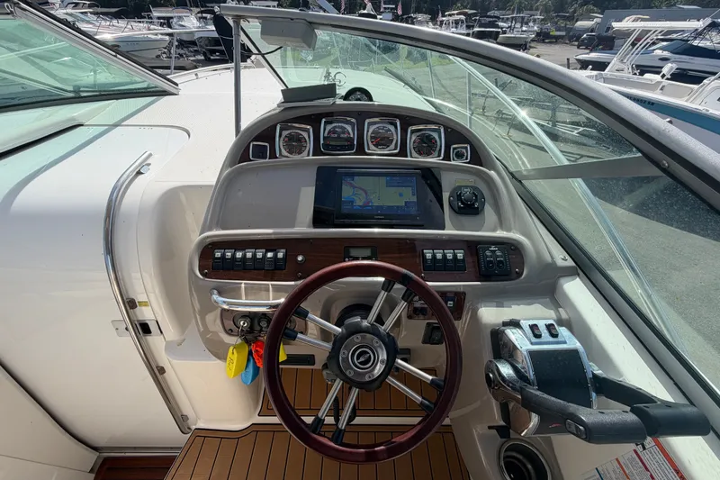 Slide: The Image of Cockpit view of 2008 Chaparral Signature 290 boat with steering wheel and navigation controls. - 31