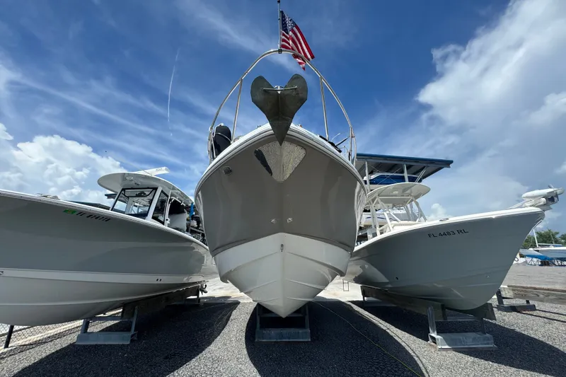 Slide: The Image of 2008 Chaparral Signature 290 boat displayed between two other boats under a clear sky. - 8