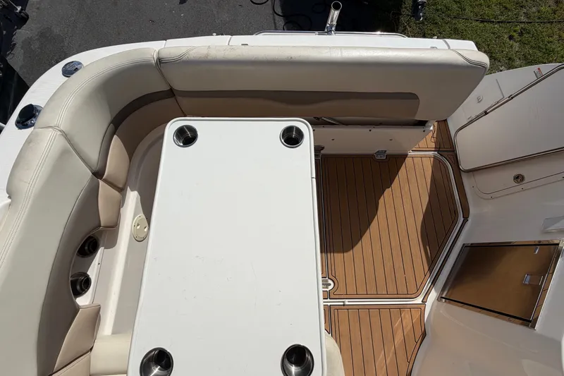 Slide: The Image of 2008 Chaparral Signature 290 boat interior with seating and table on teak flooring. - 36