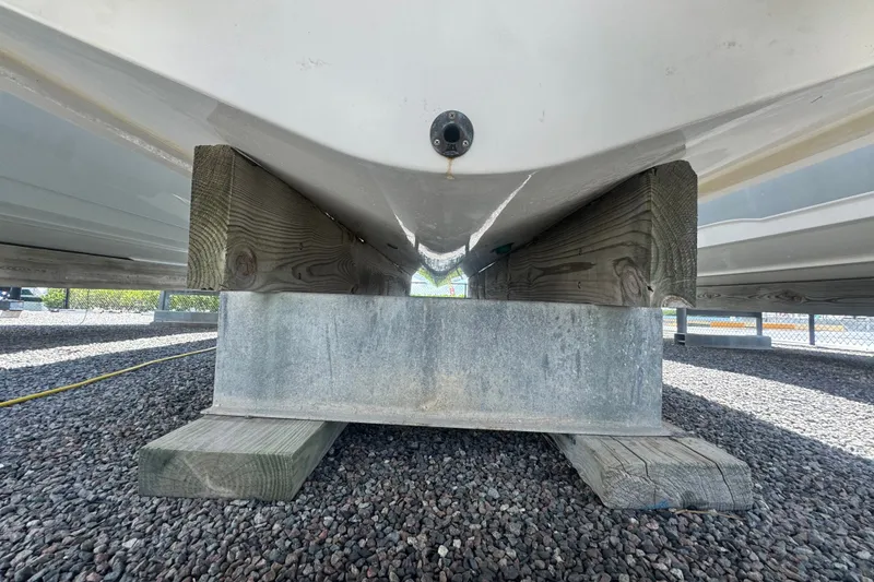 Slide: The Image of 2008 Chaparral Signature 290 boat hull resting on wooden supports. - 4