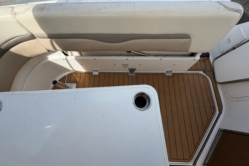 Slide: The Image of 2008 Chaparral Signature 290 boat interior with cushioned seating and wood-patterned flooring. - 113