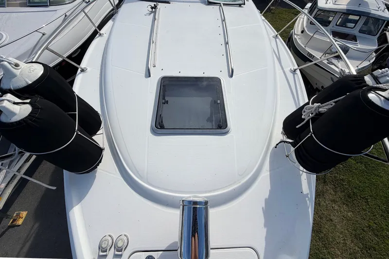 Slide: The Image of The image shows the foredeck of a 2008 Chaparral Signature 290 with a hatch window. - 31
