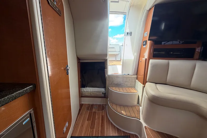 Slide: The Image of Interior of 2008 Chaparral Signature 290 yacht with seating, stairs, and a TV. - 82