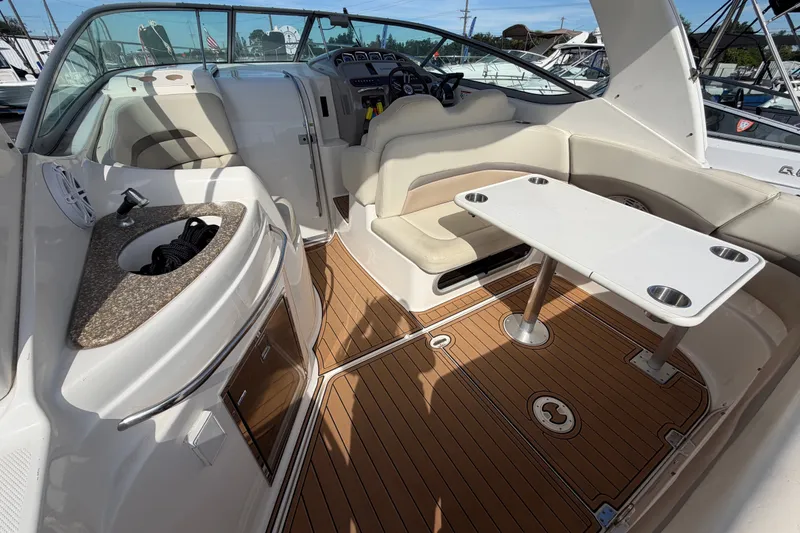 Slide: The Image of 2008 Chaparral Signature 290 boat interior with seating, table, and sink. - 12