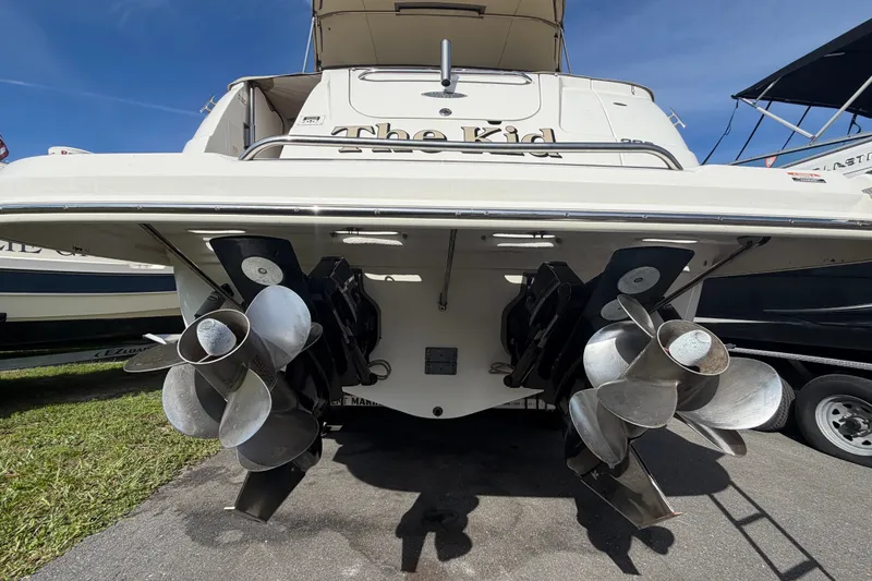 Slide: The Image of 2008 Chaparral Signature 290 boat stern with dual propellers, docked on pavement. - 3