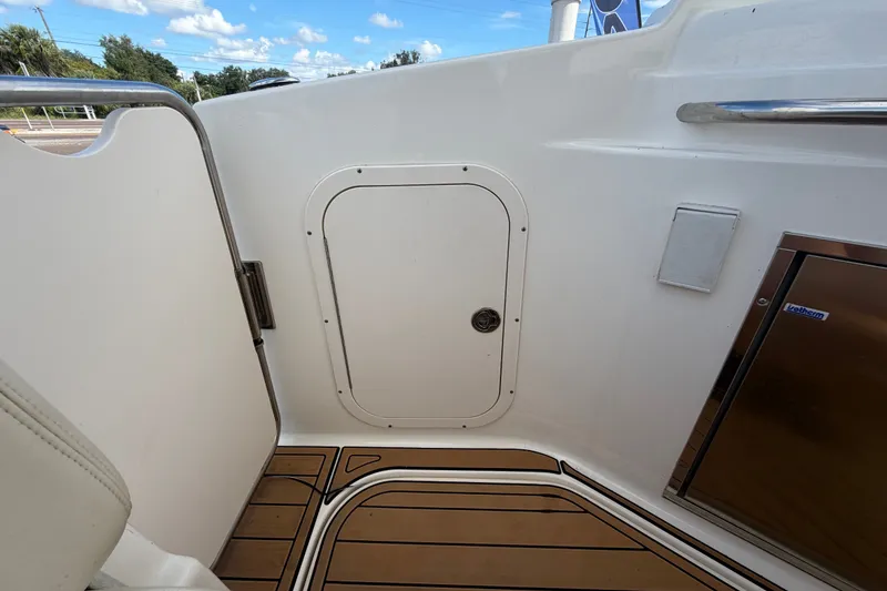 Slide: The Image of 2008 Chaparral Signature 290 boat interior with teak flooring and storage compartments. - 114