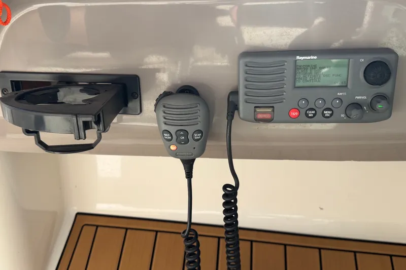Slide: The Image of A radio and cup holder are mounted on a boat's wall. - 41